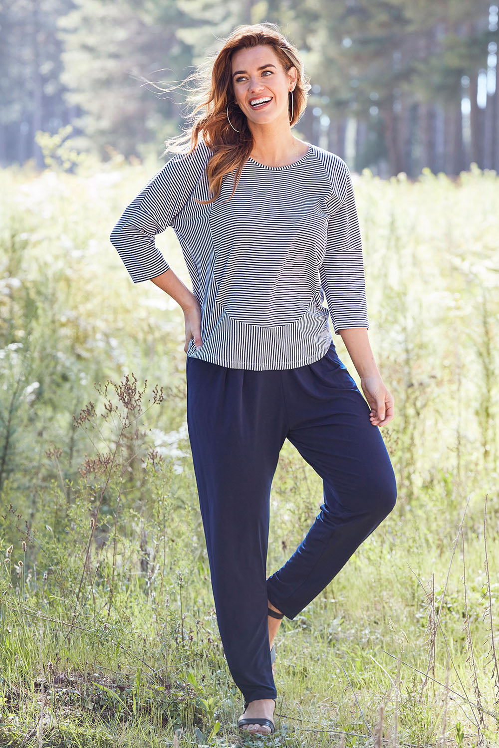 Model Laura wearing size 14 of The Comfort Pant in colour Navy (Blue), from the front, showing the whole outfit