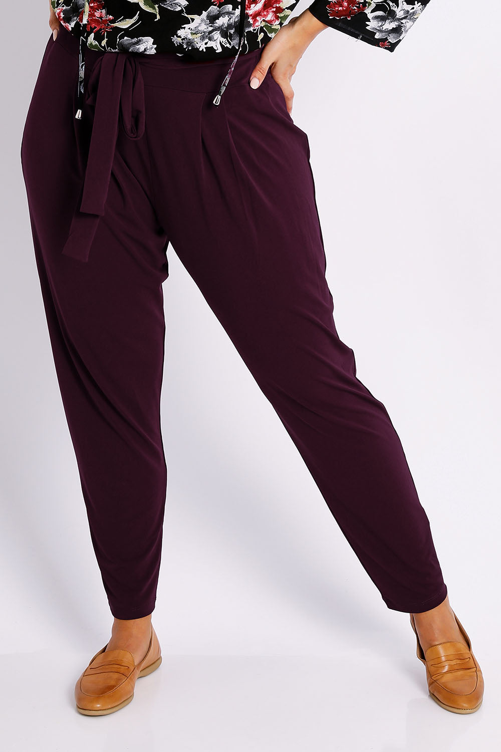 Model Jessica wearing size 14 of The Comfort Pant in colour Port (Red), from the front, cropped image