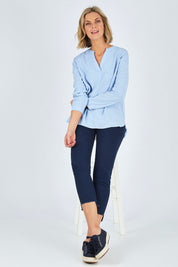 Model Chelsea wearing size 10 of The Skinny Step Hem Jean in colour Blue (Blue), from the front, showing the whole outfit