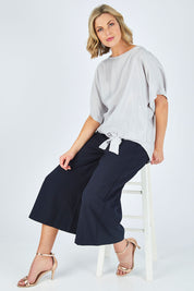 Model Chelsea wearing size 10 of The Luxe Tie Front Top in colour Silver (Grey), from the front, showing the whole outfit