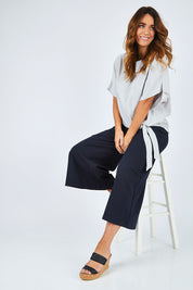 Model Laura wearing size 14 of The Luxe Tie Front Top in colour Silver (Grey), from the front, showing the whole outfit