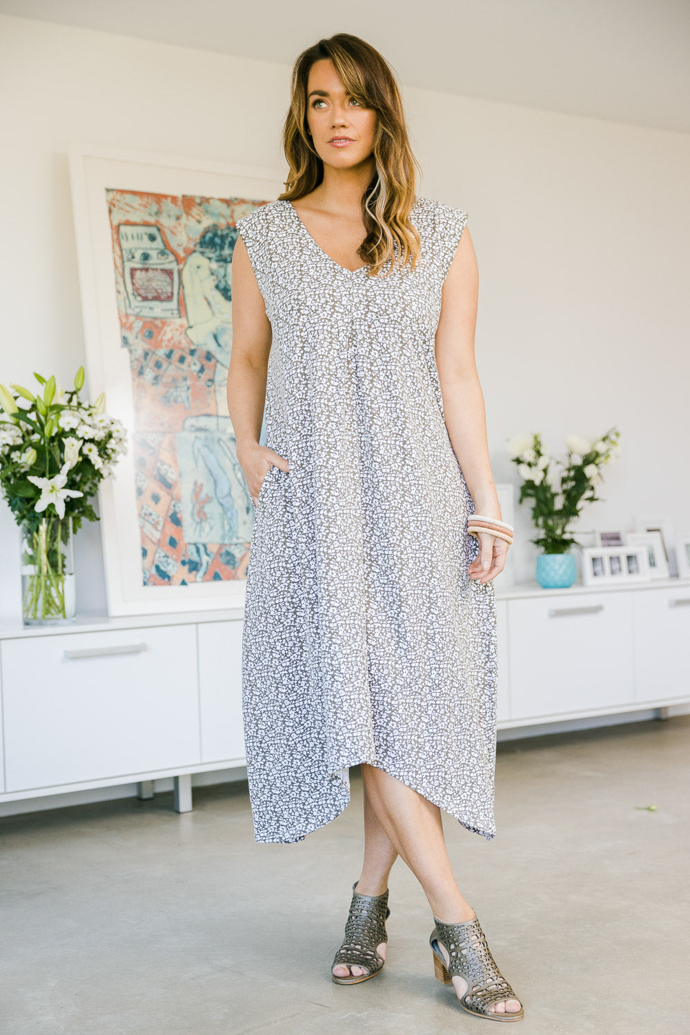 Model Laura wearing size 14 of The Uneven Hem Dress in colour Khaki (Green), from the front, showing the whole outfit