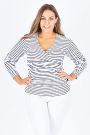 Model Natalia wearing size 14 of The Wrap Jersey Top in colour NavyStripe (Blue), from the front, cropped image