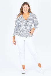 Model Natalia wearing size 14 of The Wrap Jersey Top in colour NavyStripe (Blue), from the front, showing the whole outfit