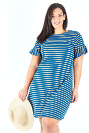 Model Lauren wearing size 18 of The Cotton Bamboo Frill Dress in colour Bluegold (Blue), from the front, cropped image