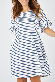 Model Laura wearing size 14 of The Cotton Bamboo Frill Dress in colour Navystripe (Blue), from the front, cropped image