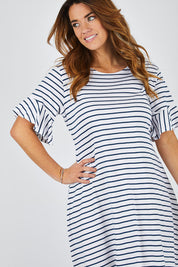 Model Laura wearing size 14 of The Cotton Bamboo Frill Dress in colour Navystripe (Blue), from the front, cropped image