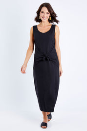 Model Andrea wearing size 10 of The Tie Waist Tank Dress in colour Black (Black), from the front, showing the whole outfit