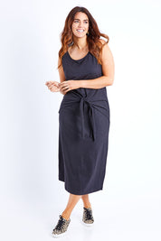 Model Laura wearing size 14 of The Tie Waist Tank Dress in colour Black (Black), from the front, showing the whole outfit