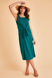 Model Madeline wearing size 10 of The Tie Waist Tank Dress in colour Turquoise (Green), from the front, showing the whole outfit