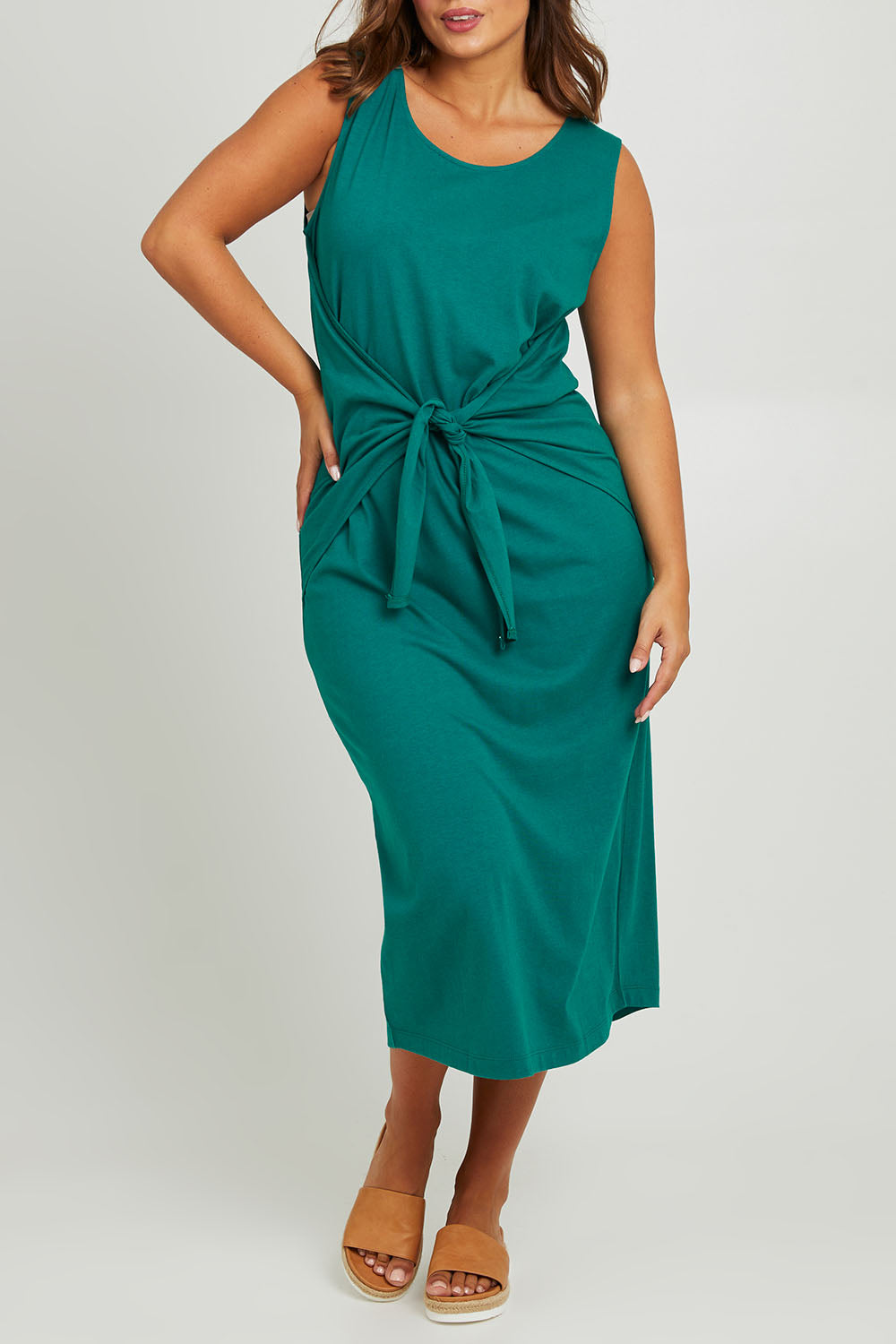 Model Monique wearing size 14 of The Tie Waist Tank Dress in colour Turquoise (Green), from the front, cropped image