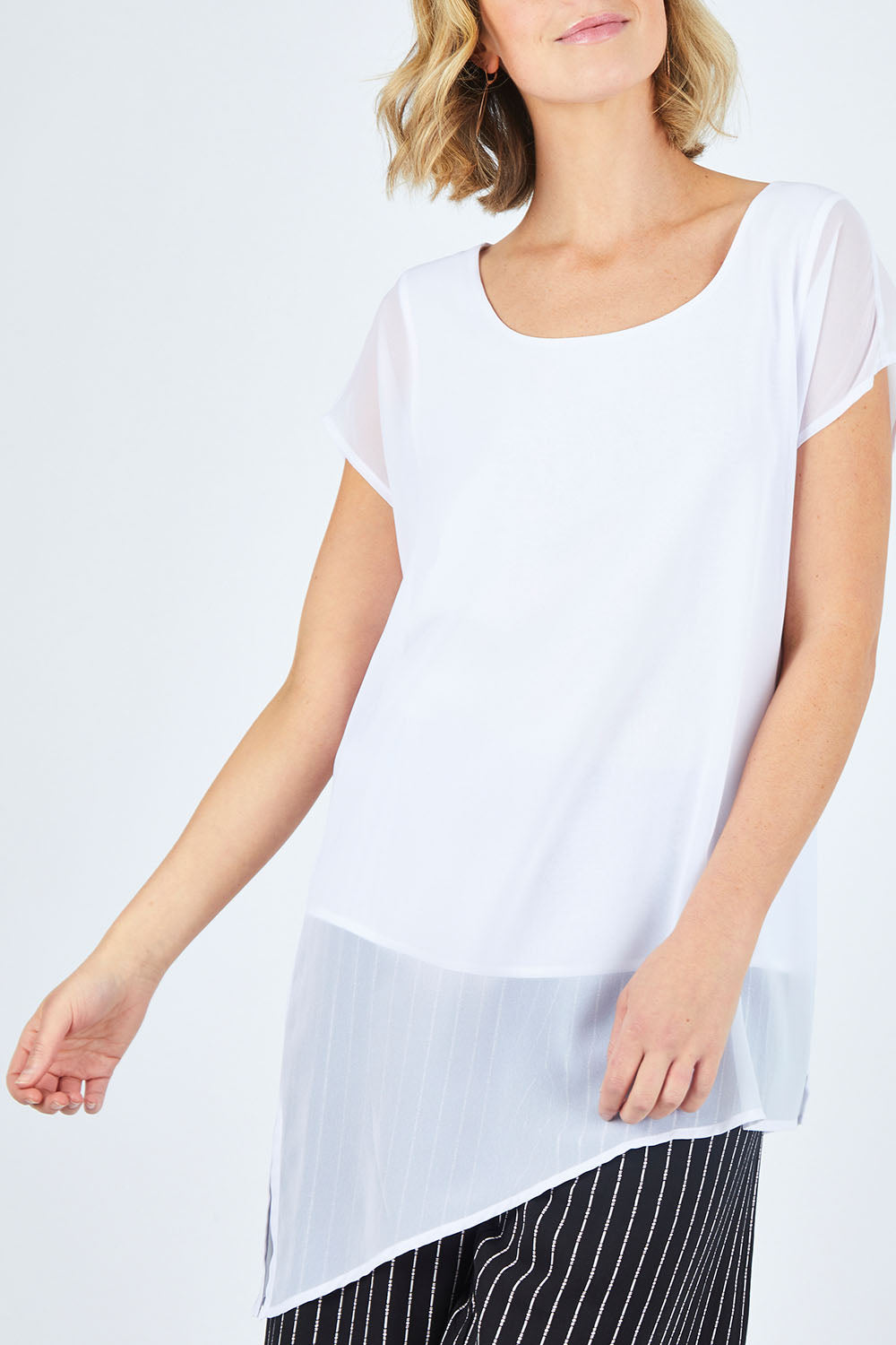 Model Chelsea wearing size 10 of The Chiffon Trim Top in colour White (White), from the front, cropped image