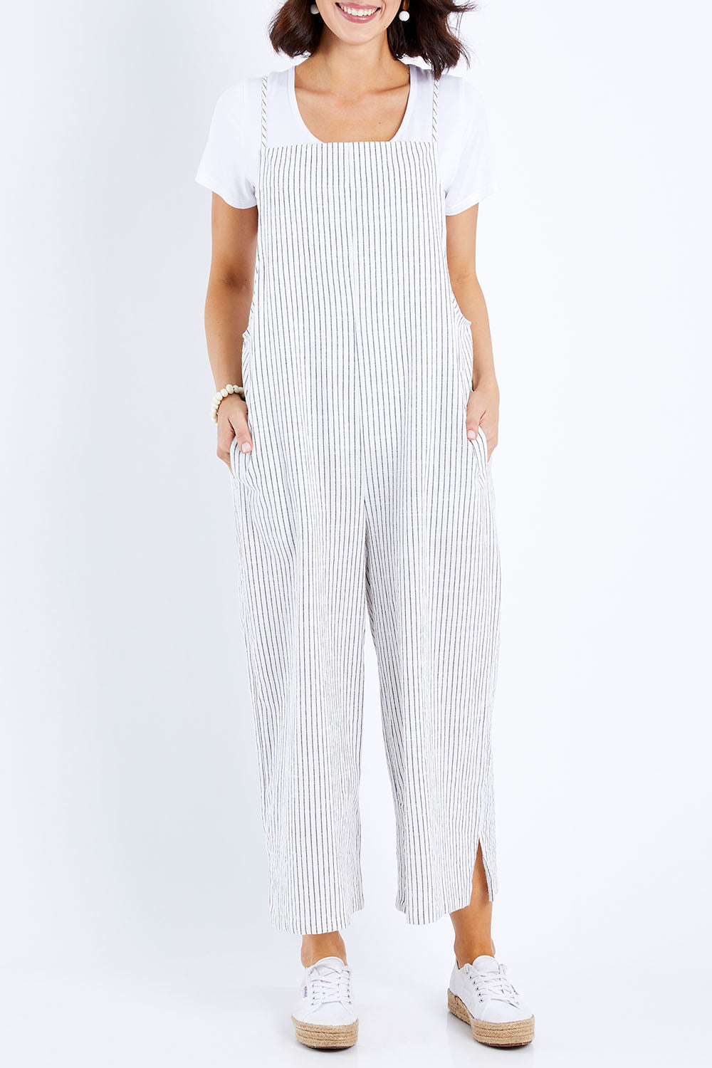 Model Andrea wearing size 10 of The Easy Day Jumpsuit in colour Whtstripe (White), from the front, cropped image