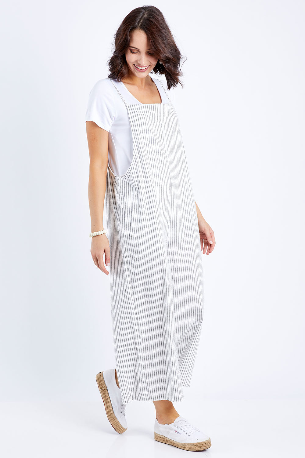 Model Andrea wearing size 8 of The Easy Day Jumpsuit in colour Whtstripe (White), from the front, showing the whole outfit