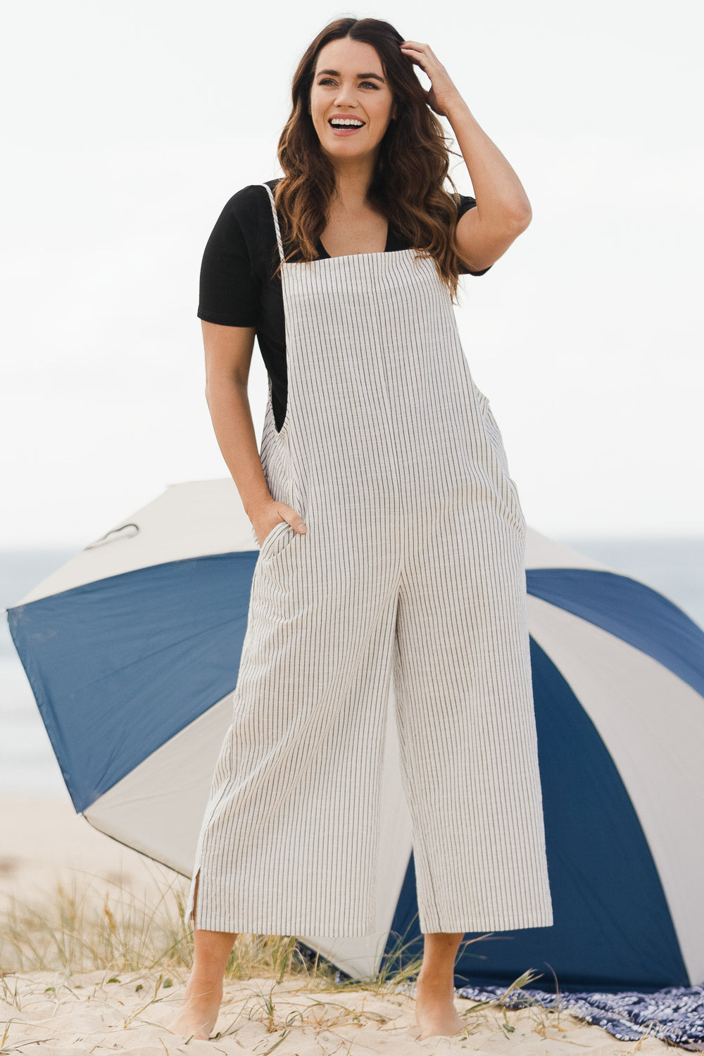 Model Laura wearing size 14 of The Easy Day Jumpsuit in colour Whtstripe (White), from the front, showing the whole outfit