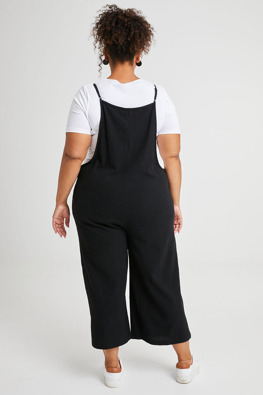 Model Alexis wearing size 16 of The Easy Day Jumpsuit in colour Black (Black), from the back