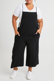 Model Alexis wearing size 16 of The Easy Day Jumpsuit in colour Black (Black), from the front, cropped image