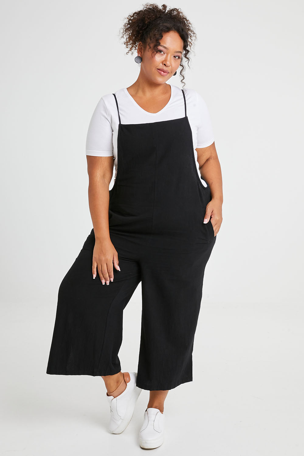 Model Alexis wearing size 16 of The Easy Day Jumpsuit in colour Black (Black), from the front, showing the whole outfit