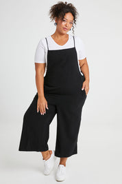 Model Alexis wearing size 16 of The Easy Day Jumpsuit in colour Black (Black), from the front, showing the whole outfit
