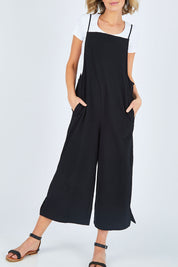 Model Chelsea wearing size 10 of The Easy Day Jumpsuit in colour Black (Black), from the front, cropped image