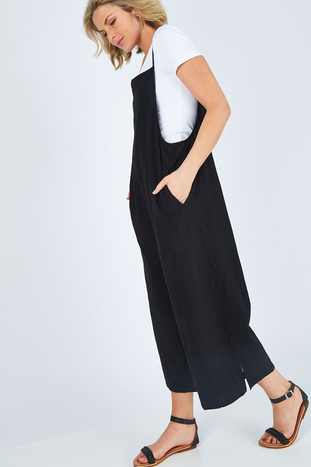 Model Chelsea wearing size 10 of The Easy Day Jumpsuit in colour Black (Black), from the front, showing the whole outfit