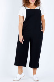Model Jess wearing size 16 of The Easy Day Jumpsuit in colour Black (Black), from the front, cropped image