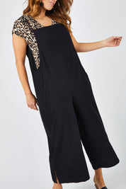 Model Laura wearing size 14 of The Easy Day Jumpsuit in colour Black (Black), from the front, cropped image