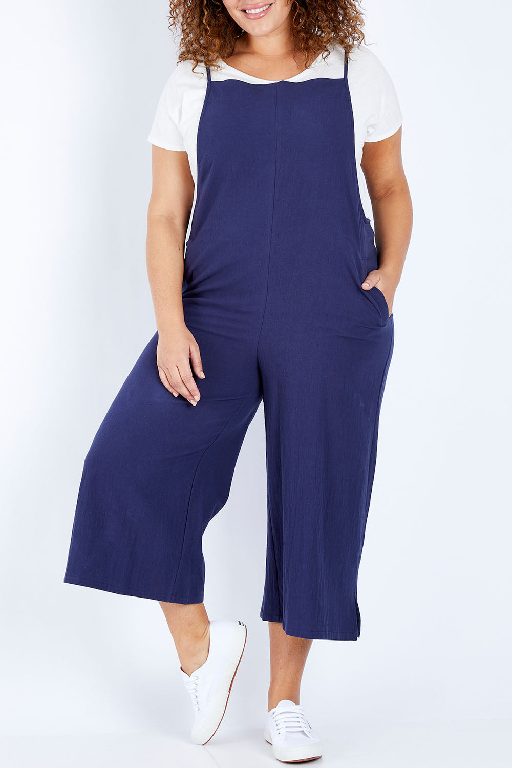 Model Jess wearing size 16 of The Easy Day Jumpsuit in colour Navy (Blue), from the front, cropped image
