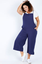 Model Jess wearing size 16 of The Easy Day Jumpsuit in colour Navy (Blue), from the front, showing the whole outfit