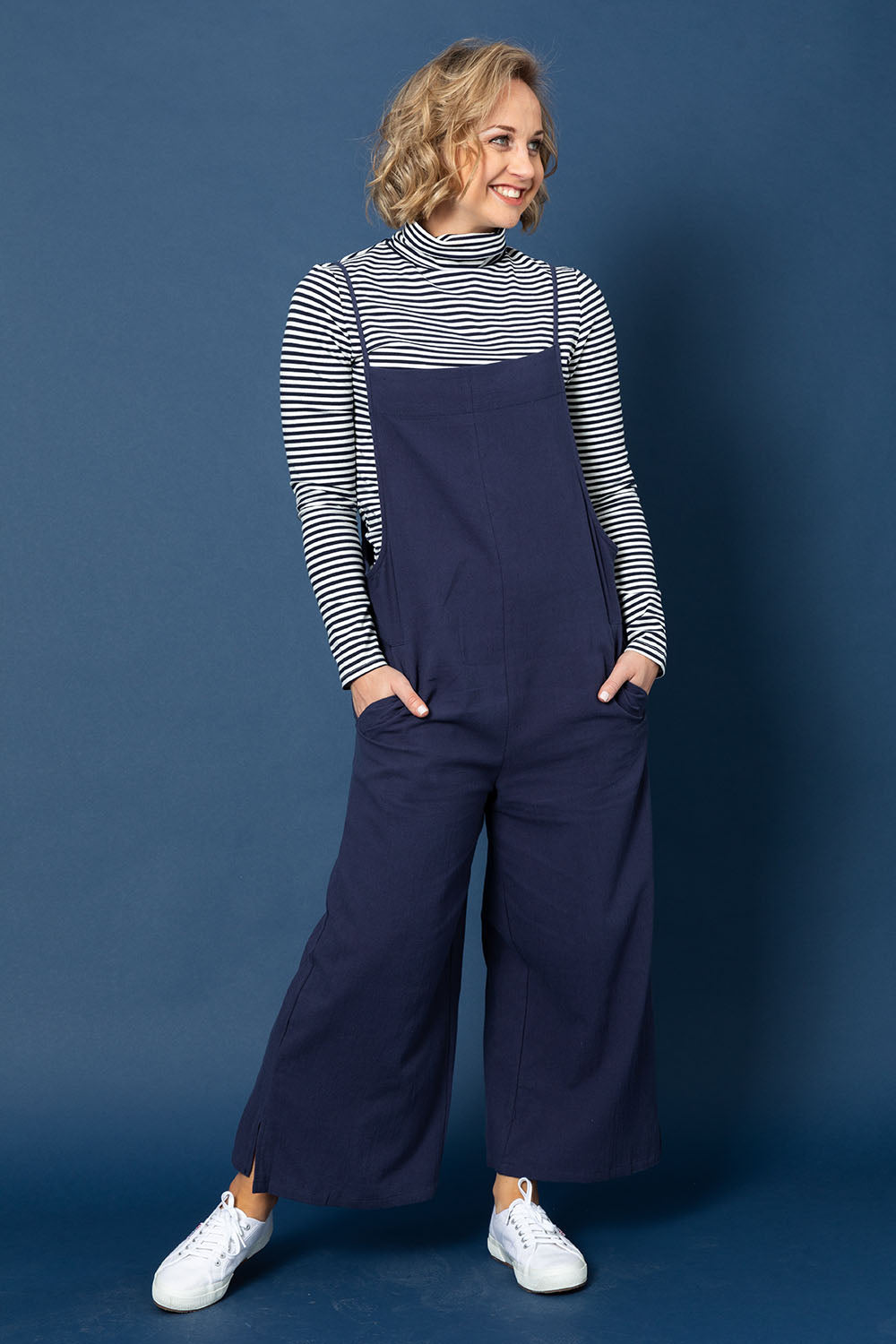 Model Steph wearing size 10 of The Easy Day Jumpsuit in colour Navy (Blue), from the front, showing the whole outfit