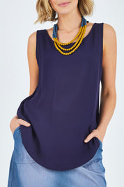 Model Chelsea wearing size 10 of The Reversible Tank in colour Navy (Blue), from the front, cropped image