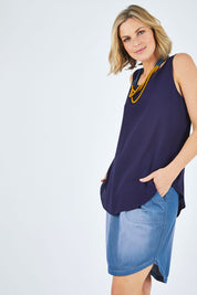 Model Chelsea wearing size 10 of The Reversible Tank in colour Navy (Blue), from the front, cropped image