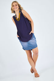 Model Chelsea wearing size 10 of The Reversible Tank in colour Navy (Blue), from the front, showing the whole outfit