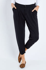 Model Elhana wearing size 10 of The Winter Best Seller Pant in colour Black (Black), from the front, cropped image