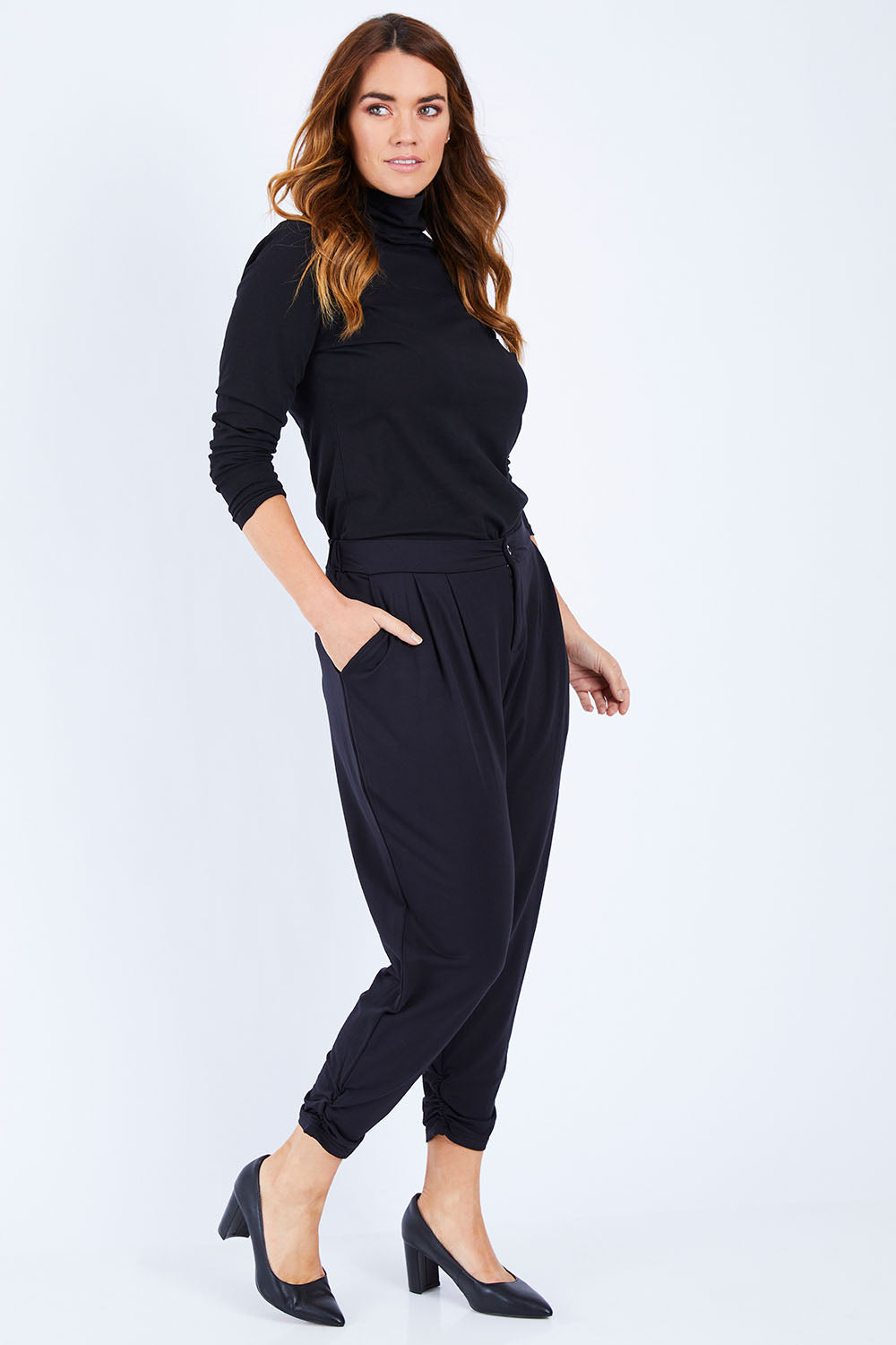 Model Laura wearing size 14 of The Winter Best Seller Pant in colour Black (Black), from the front, showing the whole outfit