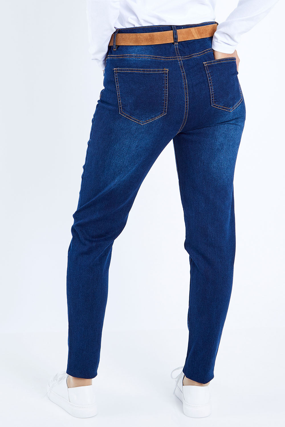 Model Kimberley wearing size 10 of The Mid Rise Skinny Jean in colour Denim (Blue), from the back