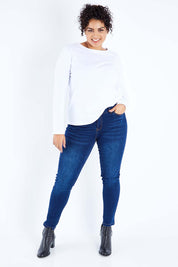 Model Sasha-Lee wearing size 16 of The Mid Rise Skinny Jean in colour Denim (Blue), from the front, showing the whole outfit