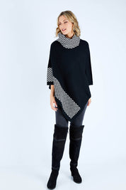 Model Chelsea wearing size S-M of The Patterned Removable Roll Neck Poncho in colour Blackprint (Black), from the front, showing the whole outfit