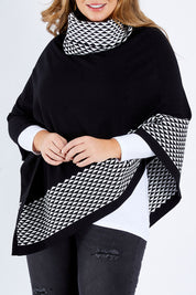 Model Fiona wearing size L-XL of The Patterned Removable Roll Neck Poncho in colour Blackprint (Black), from the front, cropped image
