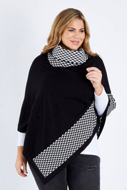 Model Fiona wearing size L-XL of The Patterned Removable Roll Neck Poncho in colour Blackprint (Black), from the front, cropped image
