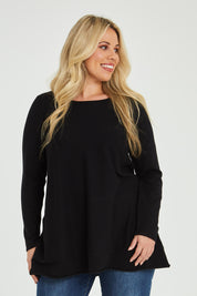 Model Katie wearing size XL of The Swing Knit in colour Black (Black), from the front, cropped image