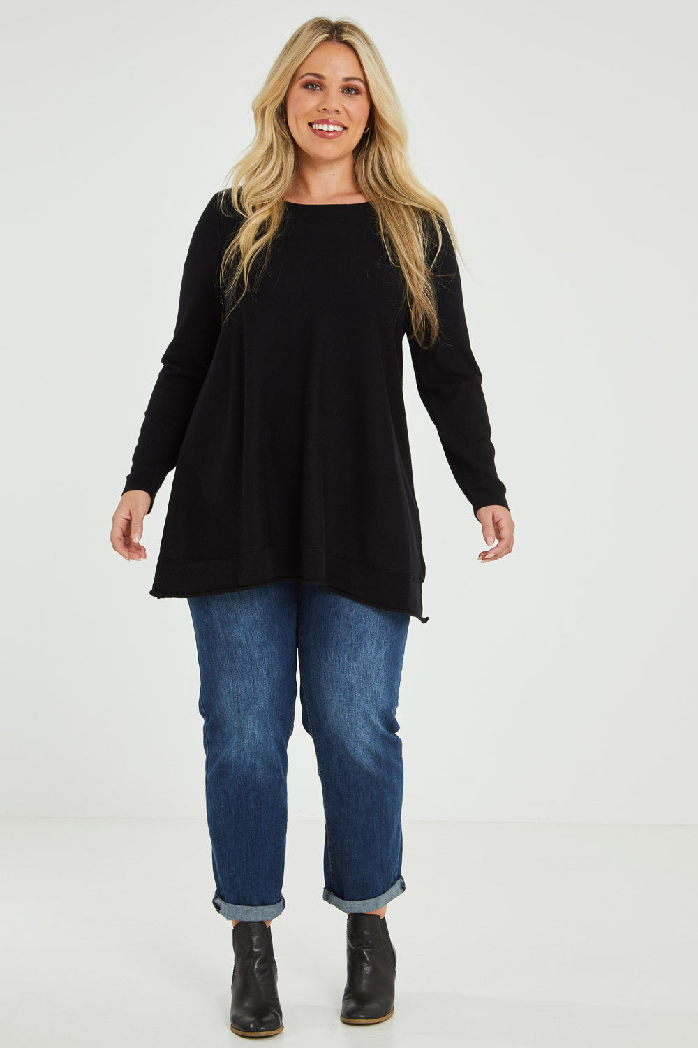 Model Katie wearing size XL of The Swing Knit in colour Black (Black), from the front, showing the whole outfit