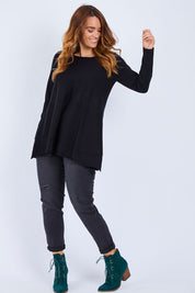 Model Laura wearing size L of The Swing Knit in colour Black (Black), from the front, showing the whole outfit