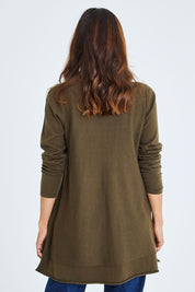 Model Cara wearing size S of The Swing Knit in colour Khaki (Green), from the back