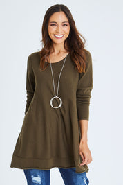 Model Cara wearing size S of The Swing Knit in colour Khaki (Green), from the front, cropped image