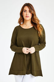 Model Laura wearing size L of The Swing Knit in colour Khaki (Green), from the front, cropped image