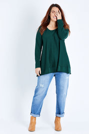 Model Laura wearing size M of The Swing Knit in colour Pinegreen (Green), from the front, showing the whole outfit