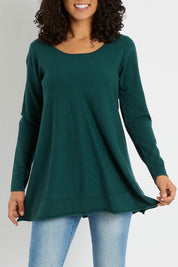 Model Pamela wearing size S of The Swing Knit in colour Pinegreen (Green), from the front, cropped image
