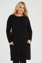 Model Katie wearing size XL of The Pocket Detail Dress in colour Black (Black), from the front, cropped image