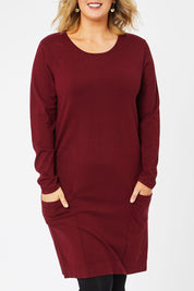 Model Jess wearing size L of The Pocket Detail Dress in colour Burgundy (Red), from the front, cropped image
